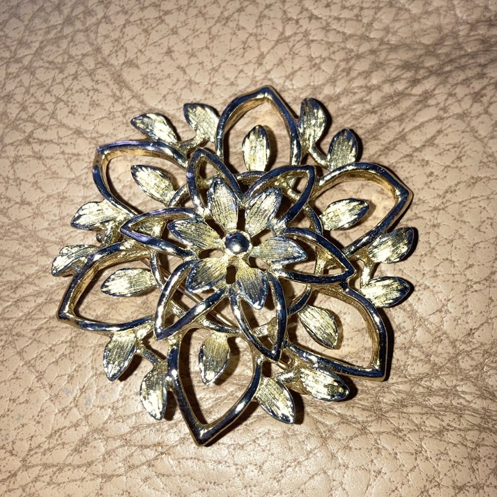 Signed Sarah Coventry Silvertone pin
resembling a flower or snowflake $19